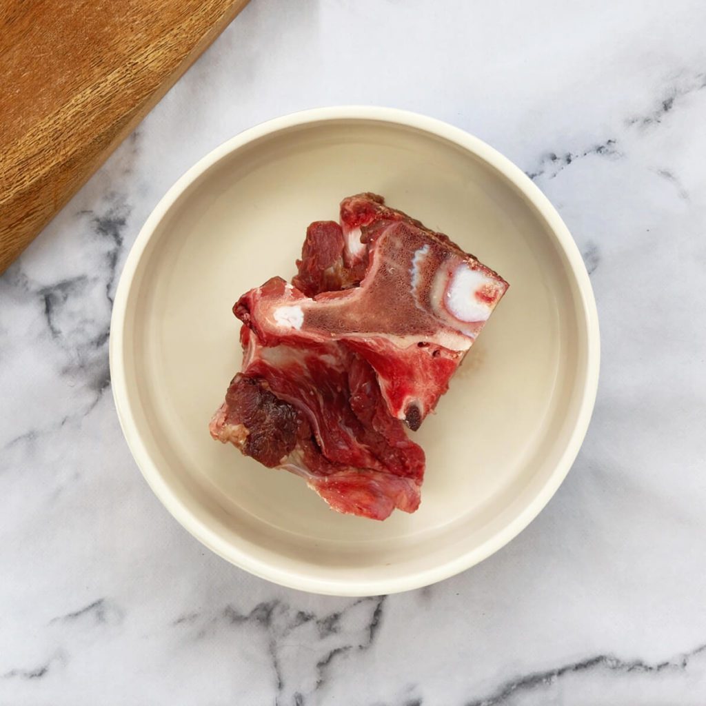 Beef neck bones in a dog bowl