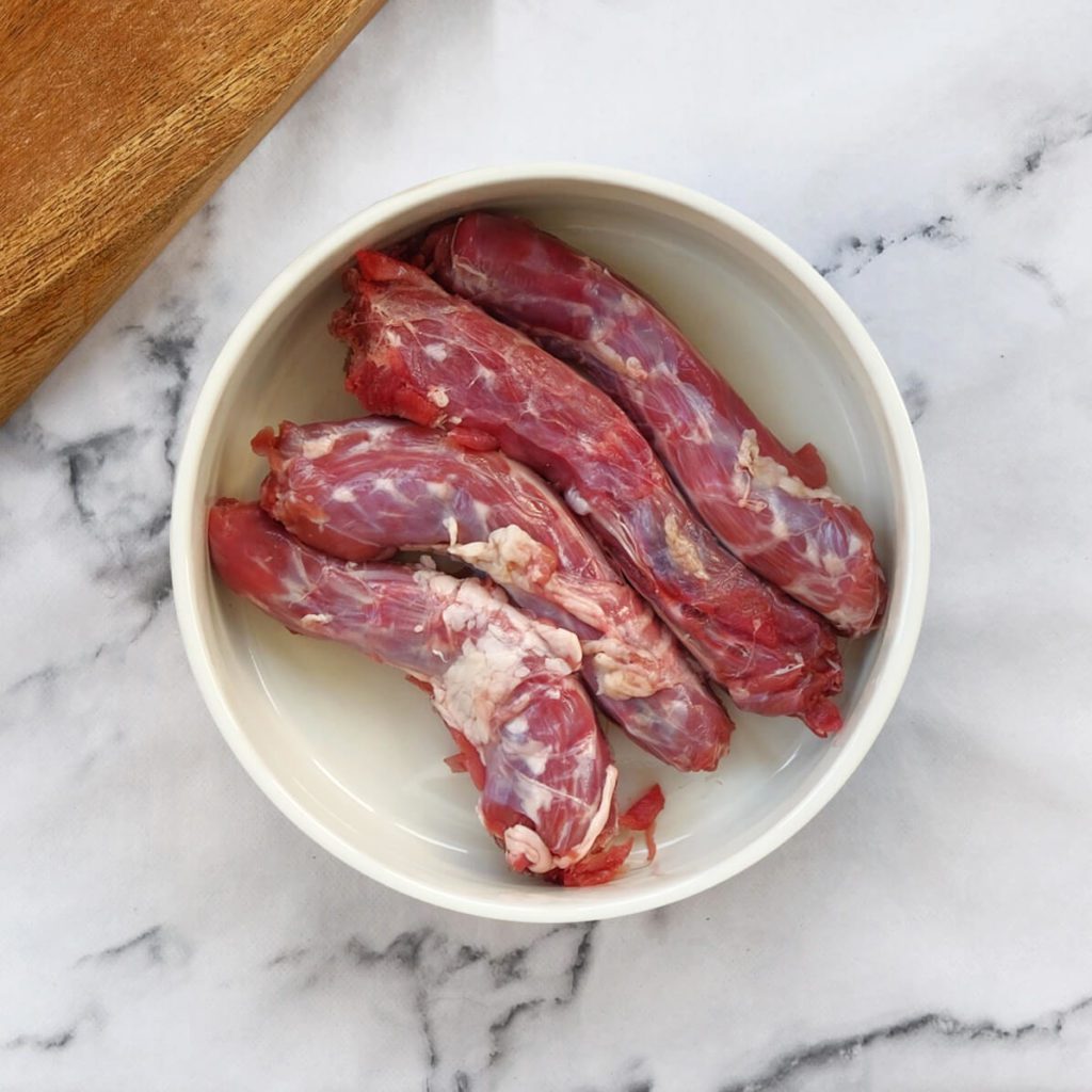 Duck necks in a dog bowl