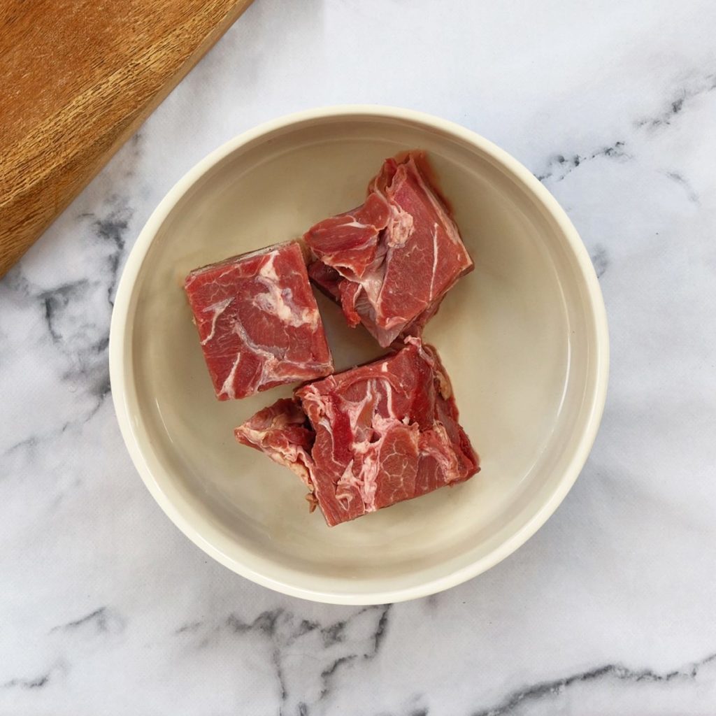 Lamb chunks in a dog bowl