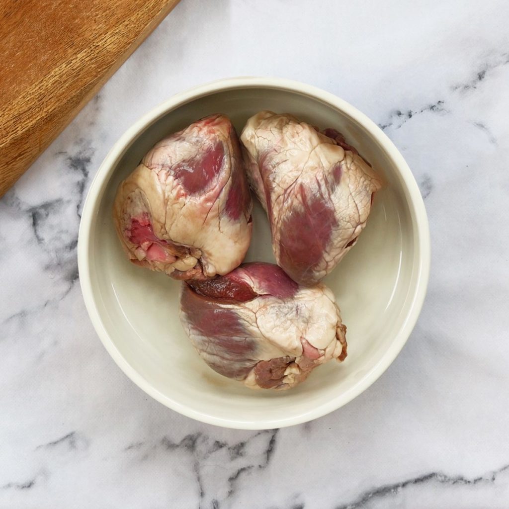 Lamb hearts in a dog bowl