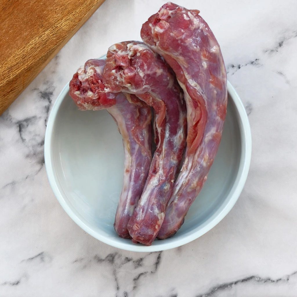 Turkey neck bones in a dog bowl