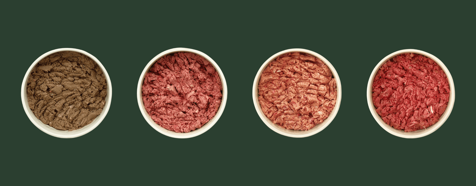 A selection of bowls filled with different raw dog food